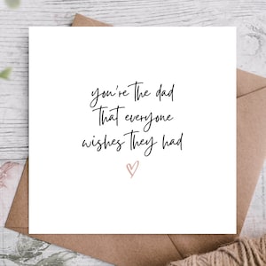 May include: White card with black calligraphy that reads "You're the dad that everyone wishes they had" with a pink heart at the bottom.