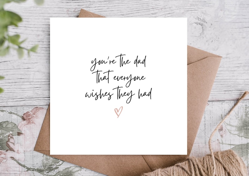May include: White card with black calligraphy that reads "You're the dad that everyone wishes they had" with a pink heart at the bottom.