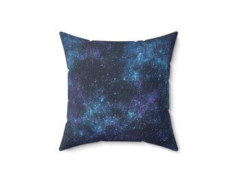 May include: A square throw pillow with a dark blue background and a galaxy print featuring white and blue stars.