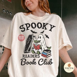 halloween book lover png for sublimation, spooky ghost alligator reading design, retro readers book club shirt png, cute crocodile in ghost costume clipart, funny gator bookworm digital artwork, halloween reading club graphic, ghost reader with coffin and stacked books, spooky season bookish png, librarian halloween gift design, horror reader digital download, transparent png for t shirts hoodies mugs tumblers tote bags bookmarks stickers signs dtf transfers and handmade products, halloween gift