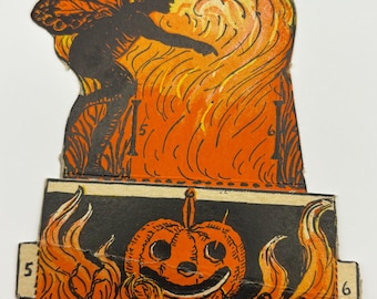 May include: Vintage Halloween die-cut decoration featuring a silhouetted fairy with butterfly wings against an orange and yellow flame background. A smiling jack-o'-lantern is below. Numbers 4, 5, and 6 are visible.