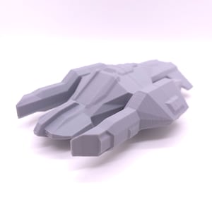 May include: A grey 3D printed model of a spaceship with a sleek, angular design. The model has a pointed nose and two large wings.