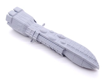 May include: A gray 3D printed model of a spaceship. The model is detailed with a long, narrow body and a rounded nose.