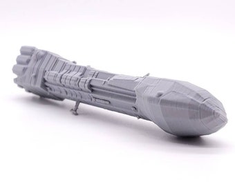 May include: A gray 3D printed model of a futuristic spaceship with a pointed nose and a detailed engine section.