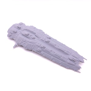 May include: A grey, detailed model of a spaceship with a long, narrow design. The model has a textured surface and features multiple small details, including a cockpit, engines, and weapons.