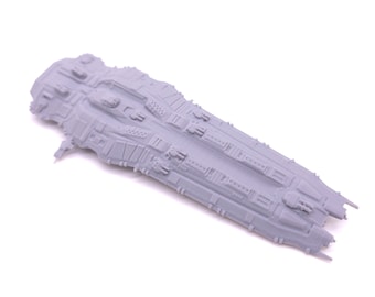 May include: A gray, detailed model of a spaceship with a long, narrow design. The model has a textured surface and features multiple small details, including a cockpit, engines, and weapons.