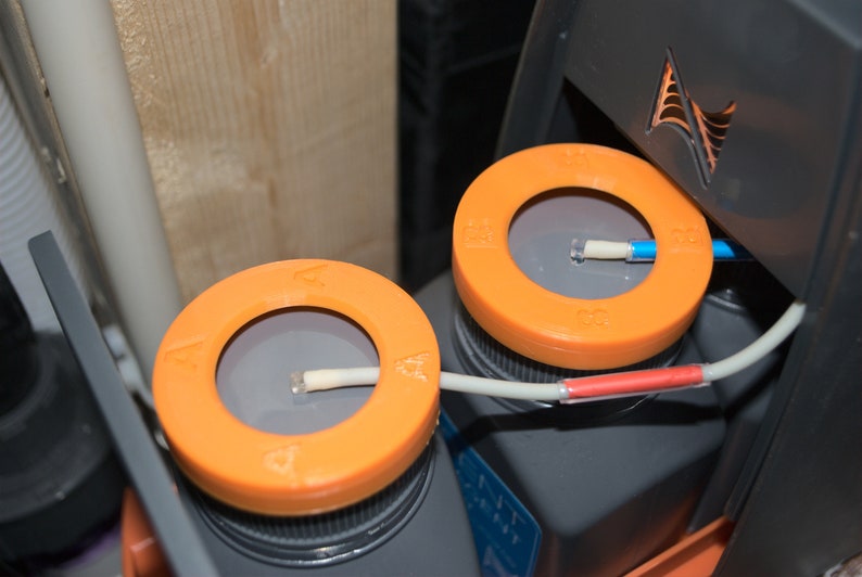 May include: Two orange and gray water test kits with white tubes and red and blue connectors. The kits are labeled with the letters "A" and "B".
