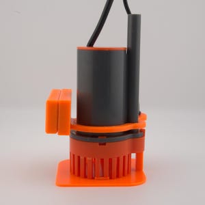 May include: An orange and gray submersible pump with a black power cord. The pump has a cylindrical gray body, an orange base, and an orange rectangular component on the side. The base has vertical orange fins.