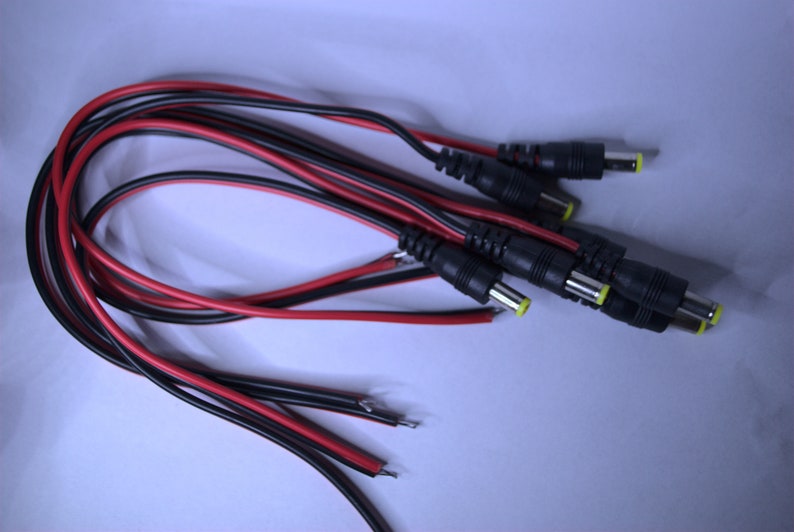 May include: A bundle of black and red electrical wires with multiple black connector plugs with yellow tips.