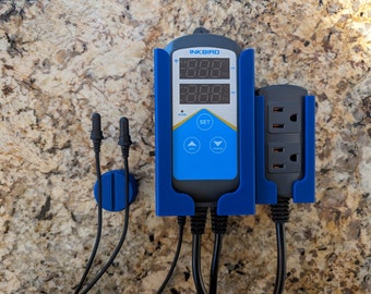 May include: A blue Inkbird smart outlet with a digital display showing the temperature, a power button, and a set button. The outlet has two plugs and is mounted on a wall.