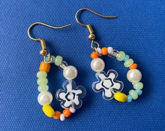Handmade funky beaded earrings. Glass floral, pearl and bright seed beads in a circular pattern on gold plated ear wires