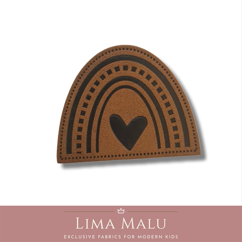 May include: Brown leather patch with a black rainbow and heart design. The rainbow has a dotted border.