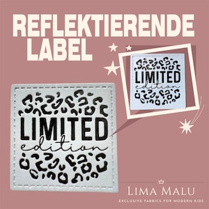 Può includere: Etichetta in tessuto bianco con testo nero che recita "LIMITED edition" circondata da una stampa leopardata nera. L'etichetta è un materiale riflettente.