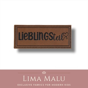 May include: Brown leather label with black stitching and the text "LieblingSteil" with a heart symbol.
