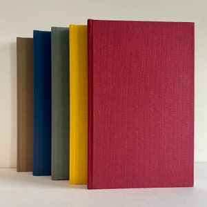 May include: Five hardcover books with different colored covers. The covers are brown, blue, green, yellow, and red.