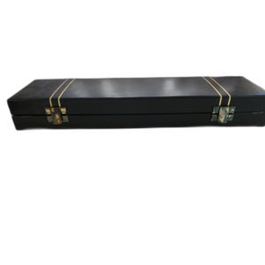 May include: A black leather case with gold trim and two clasps. The case is closed.