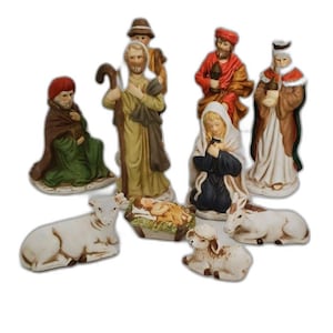 May include: A ceramic nativity set featuring figures of Mary, Joseph, the baby Jesus in a manger, the three wise men, and animals. The figures are painted in various colors, including green, red, and gold. The set is designed for Christmas.