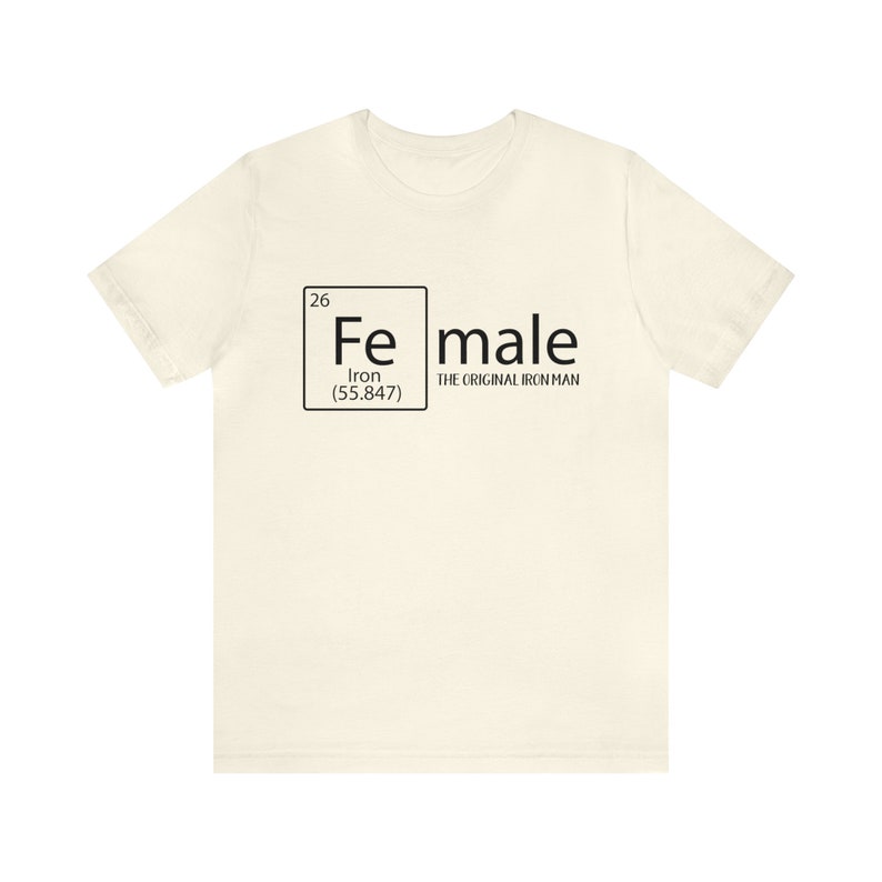 May include: A white t-shirt featuring a black graphic of a periodic table element. The element is iron, with the symbol "Fe", atomic number 26, and atomic weight 55.847. The text "male" is written next to the element box, with the words "The Original Iron Man" underneath.