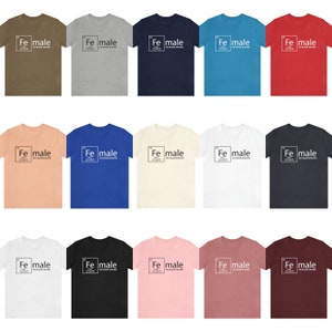 May include: A set of 18 t-shirts in various colours featuring a graphic of the chemical element iron (Fe) with the word "male" written below it. The graphic is styled to look like a periodic table element box.