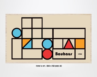 May include: A framed print of a geometric design in black, red, orange, blue, and yellow. The design features squares, circles, and triangles. The text "Bauhaus 1923" is in the lower right corner.