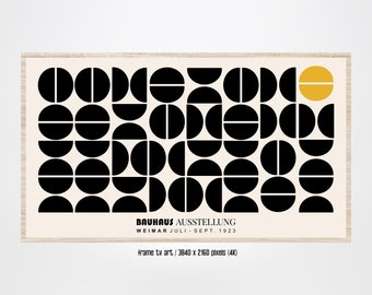 May include: A black and white geometric art print with a yellow circle in the upper right corner. The print features a repeating pattern of circles and semi-circles. The text "BAUHAUS AUSSTELLUNG WEIMAR JULI - SEPT. 1923" is printed at the bottom of the print.