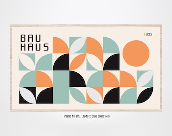May include: A framed print with a geometric design in black, orange, white, and teal. The print features the text "BAUHAUS" and the year "1923".