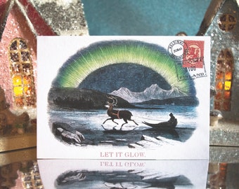 May include: A vintage postcard featuring a winter scene with a reindeer pulling a sled under the Northern Lights. The card includes a Finnish stamp and the text "Let it Glow."