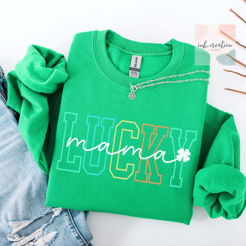 May include: Green sweatshirt with the text "LUCKY mama" in rainbow colors with a shamrock.