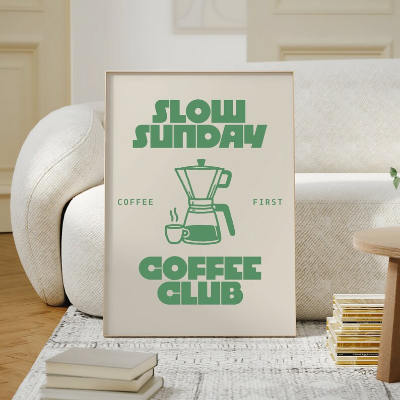 May include: A beige poster with green text that reads "Slow Sunday Coffee Club". The poster features a green illustration of a coffee pot and a coffee cup.