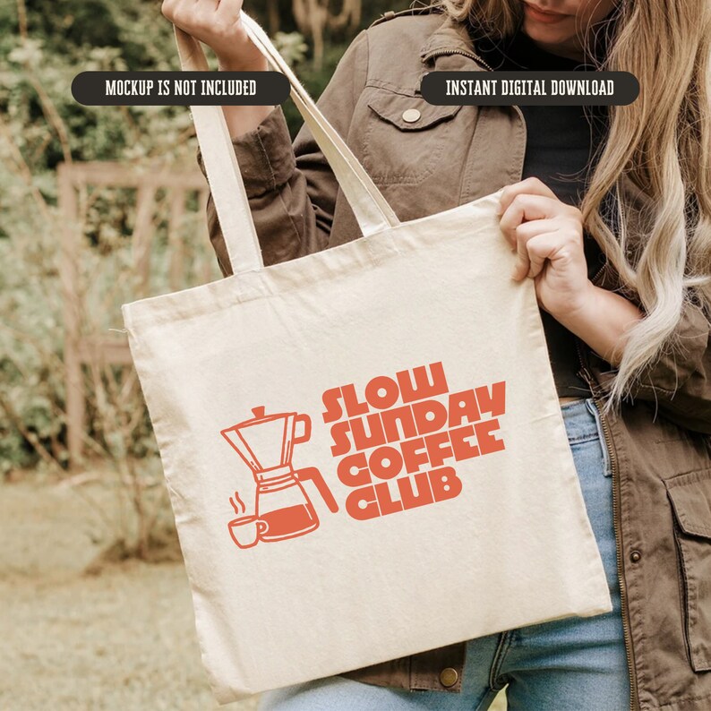May include: A white canvas tote bag with a red graphic design that says "Slow Sunday Coffee Club" and features a coffee pot and a coffee cup.