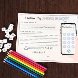 May include: A printable worksheet with a phone-shaped graphic and a section for writing a phone number. The worksheet includes the text "I Know My Phone Number" and "Emergency? Dial 911".