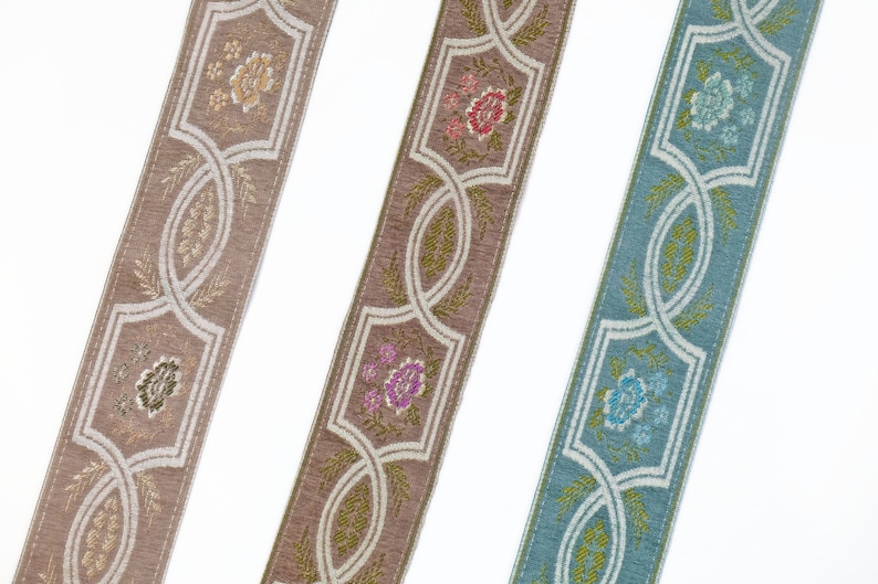 May include: Three different trims of fabric ribbon with a floral pattern. The trims are in shades of beige, brown, and blue.