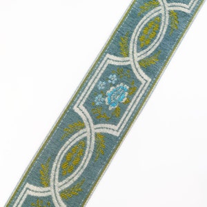 May include: A blue and white patterned trim with a floral design in shades of blue and green.