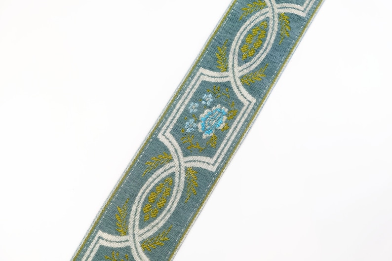 May include: A blue and white patterned trim with a floral design in shades of blue and green.