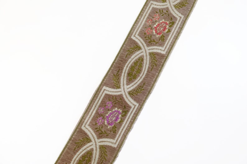 May include: A brown and white trim with a floral pattern. The trim features pink, red, and green flowers.