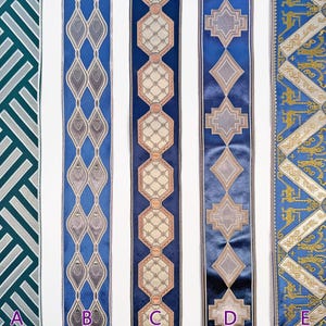 May include: Five decorative ribbons with various patterns. The ribbons are in shades of blue, teal, and gold. Designs include geometric shapes, diamond patterns, and ornate scrollwork. The ribbons are displayed vertically against a white background.
