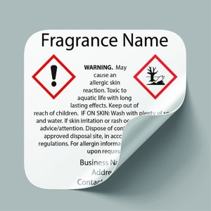 May include: White square warning label with red border and exclamation point symbol. Text reads "WARNING. May cause an allergic skin reaction. Toxic to aquatic life with long lasting effects. Keep out of reach of children. IF ON SKIN: Wash with plenty of soap and water. If skin irritation or rash occurs, seek medical advice/attention. Dispose of contents to an approved disposal site, in accordance with local regulations. For allergen information, contact [business name] upon request. Business Name, Address, Contact"
