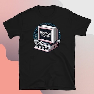 May include: Black t-shirt with a retro computer graphic and the text "NO CODE FOUND:" in a pixelated font.