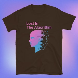 May include: A brown t-shirt with the text "Lost In The Algorithm" in pink. The shirt features a graphic of a person's head in pink and blue, with binary code cascading down the right side.
