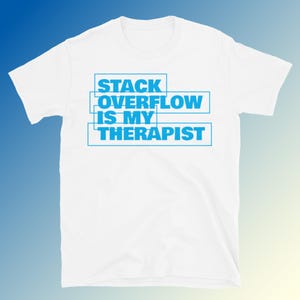 May include: A white t-shirt featuring the blue text "STACK OVERFLOW IS MY THERAPIST". The text is in a block font, arranged in three lines, each within a blue rectangular border. The shirt has a crew neck and short sleeves.