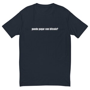 May include: A dark blue t-shirt with the text "puedo pagar con bitcoin?" printed in white on the front.