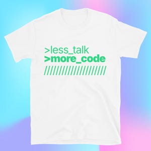 May include: White t-shirt featuring the green text '>less_talk >more_code' and green diagonal lines. This casual tee has a crew neck and short sleeves, perfect for everyday wear.