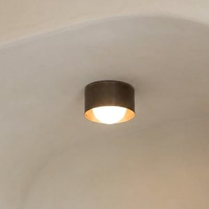 May include: A set of three ceramic mugs with a speckled, matte finish in cream, gray, and black. Each mug has a rounded shape and a simple, modern design, suitable for coffee or tea.