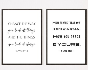May include: Two black framed prints with white backgrounds and black text. The left print reads "Change the way you look at things and the things you look at change - Wayne Dyer". The right print reads "How people treat you is their karma; how you react is yours. - Wayne Dyer".