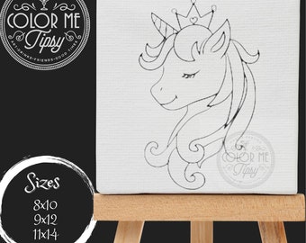 May include: A black and white line drawing of a unicorn wearing a crown on a white canvas. The canvas is on a wooden easel. The text "COLOR ME TIPSY" is visible in the lower right corner of the canvas. The text "Sizes 8x10 9x12 11x14" is visible in the lower left corner of the image.