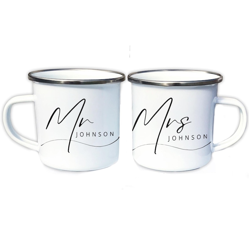 May include: Two white enamel mugs with black lettering. The mug on the left says "Mr. JOHNSON" and the mug on the right says "Mrs. JOHNSON".