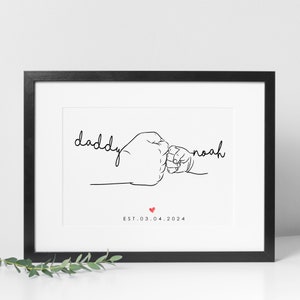 May include: Black and white line art print of two fists bumping, one larger than the other. The text "daddy" and "noah" are written above the fists. The text "EST. 03.04.2024" is written below the fists with a small red heart between the date.