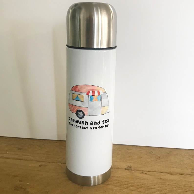 May include: White stainless steel travel mug with a cartoon illustration of a camper van and the text "caravan and tea the perfect life for me!"