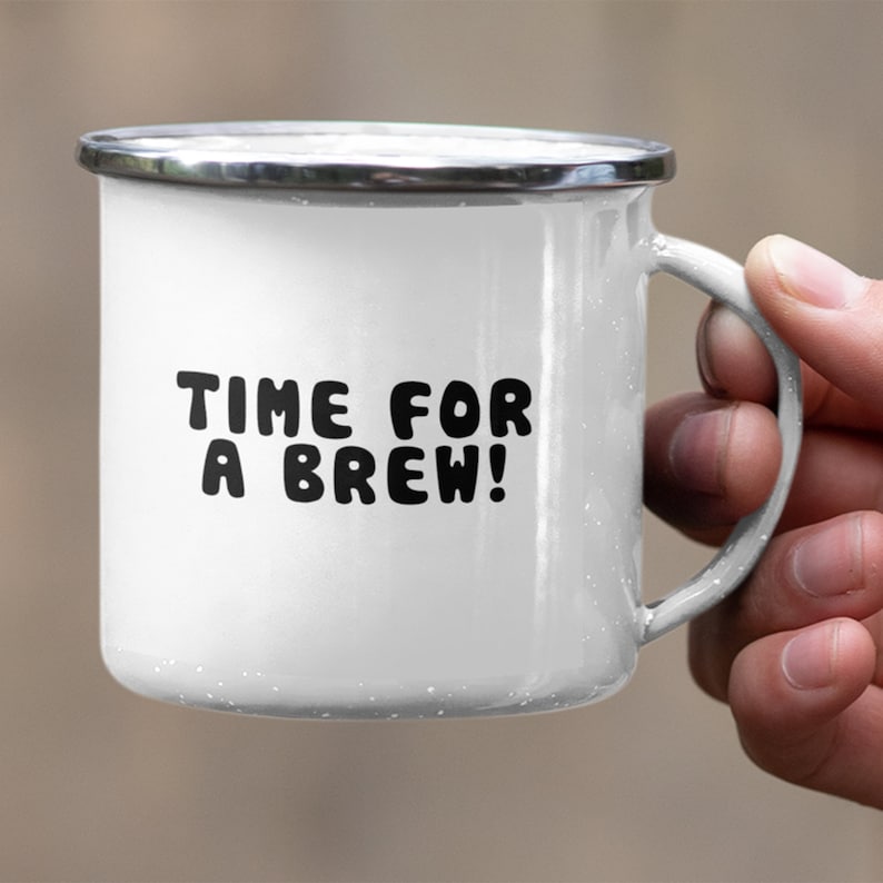 May include: White enamel mug with a black inscription that reads "TIME FOR A BREW!" The mug has a silver rim and handle.