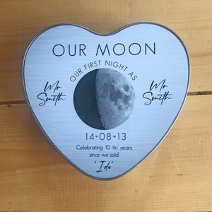May include: A silver heart-shaped tin with a moon image and the text "OUR MOON OUR FIRST NIGHT AS Mr Smith Mr Smith 14-08-13 Celebrating 10 'tin' years since we said 'I do'"